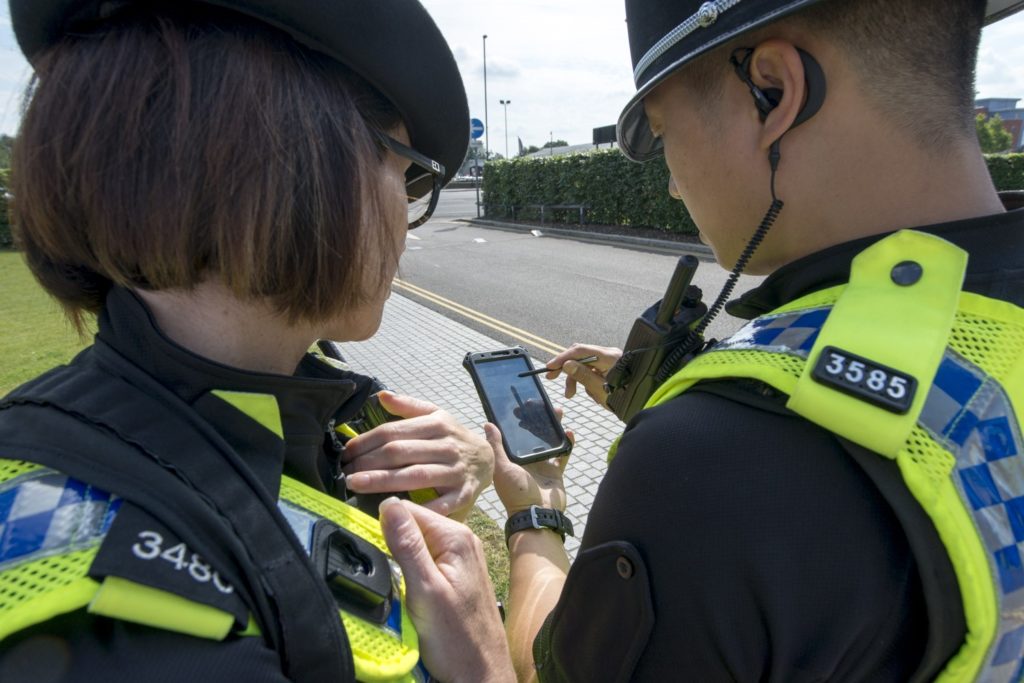 police-officers-using-a-mobile-device-while-on-duty